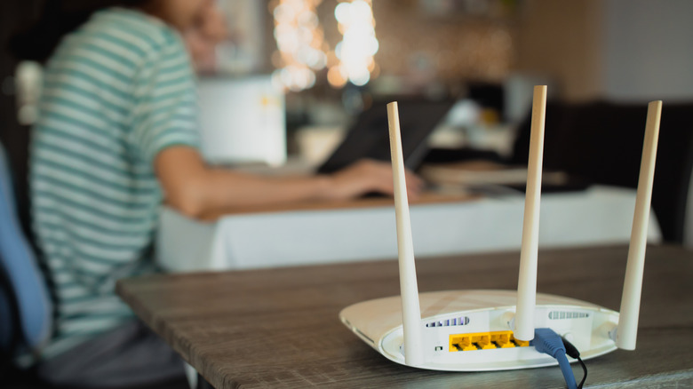 Rear view of router on table, with cable and power plugged in