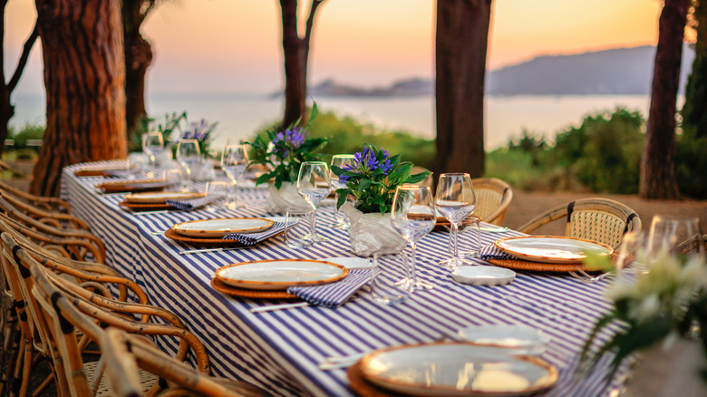beautifully set table in trees with ocean view